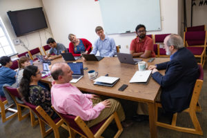 Trace faculty and students meet around a conference table