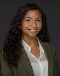 A headshot of a woman with dark hair