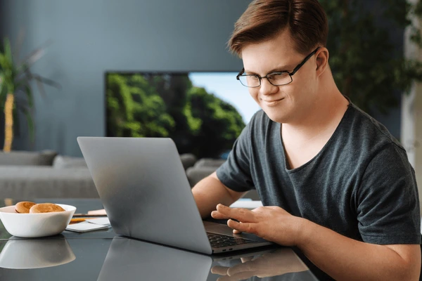 A man with Down syndrome using a computer